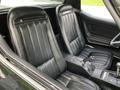 Interior of a 1972 Chevrolet Corvette featuring two leather bucket seats with horizontal stitching and a black console between them