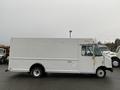 A white 2012 Ford Econoline delivery truck with a boxy body and side door for cargo access