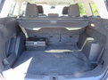 Interior of a 2015 Ford Escape showing the cargo area with a flat floor and a black storage hatch in the back