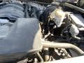 Engine compartment of a 2014 GMC Sierra 1500 showing engine components and wiring with some dust and wear visible on the surfaces