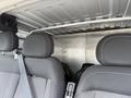 Interior view of a 2017 RAM Promaster showing the backs of two front seats and a partition separating the cabin from the cargo area