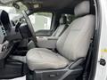 Interior view of a 2020 Ford F-350 showing the driver's seat and dashboard with gray fabric upholstery and controls visible