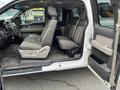 Interior of a 2010 Ford F-150 showing front and rear seats in a gray fabric with a simple design and a spacious layout