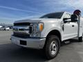 A 2017 Ford F-350 SD displayed in a white exterior with a chrome grille and rugged tires positioned at an angle