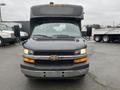 A black 2018 Chevrolet Express with a prominent front view featuring large side mirrors and a flat front grill with the Chevrolet logo