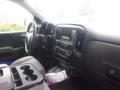 Interior view of a 2015 Chevrolet Silverado 1500 showing the dashboard steering wheel and central control panel