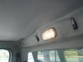 The interior ceiling of a 2005 Freightliner M2 106 Medium Duty showing a ceiling light and several clips mounted on the surface