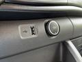 Close-up of a USB port and a 12V power outlet on the dashboard of a 2022 Ford Transit