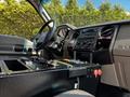 Interior view of a 2009 Ford F-550 showing the steering wheel dashboard controls and console with various buttons and switches