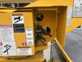 Close-up of hydraulic controls for a boom lift mounted on a 2015 Freightliner M2 106 with warning labels and mechanisms for boom rotation and elevation