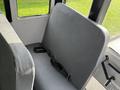A gray bench seat with a safety belt in a 2022 Freightliner B2 vehicle