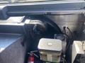 2012 Ford Econoline engine compartment featuring components like a compressor a fluid reservoir and various hoses and wires