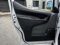 A 2020 Nissan NV200 van door with a black interior panel and a handle for opening the door