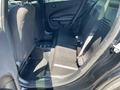 Interior view of a 2019 Dodge Charger showing the rear seats and floor space with black upholstery and seat belts