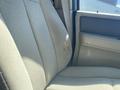 A beige seat in a 2013 Ford Expedition showing two small tears in the fabric