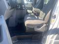 Interior view of a 2009 Ford Econoline showing the driver's seat, steering wheel, and dashboard with a focus on the driver's side space
