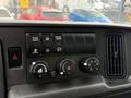 Dashboard controls of a 2022 International MV607 featuring buttons for transmission mode and parked regeneration along with various climate control knobs