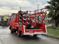 A red 2001 Toyota Dyna truck with firefighting equipment including hoses and a pump mounted in the back