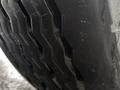 Close-up of a heavy-duty tire with a deep tread pattern designed for traction on a 2016 Freightliner 108SD