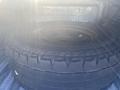 A 2021 RAM 1500 with a spare tire resting in the truck bed