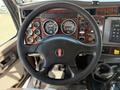 Interior view of a 2009 Kenworth T270 truck showing the steering wheel and dashboard with gauges and controls