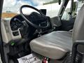Interior view of a 2017 International WorkStar 7600 featuring a gray driver's seat and dashboard with various controls and gauges visible