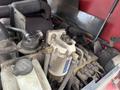 Close-up of the engine compartment of a 2012 Toro Groundsmaster 5910 showing various components including a fuel filter and hoses