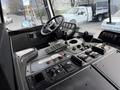 Interior cockpit view of a 2010 Autocar Xpeditor with various control panels switches and gauges visible
