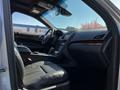 Interior view of a 2013 Lincoln MKT featuring leather seats a central console and dashboard with wood accents