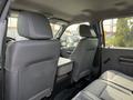 Interior of a 2011 Ford F-350 SD showing two gray front seats and a center console in the back seat area