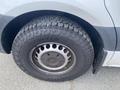 Close-up of a rugged tire on a 2024 Mercedes-Benz Sprinter featuring deep treads designed for enhanced traction