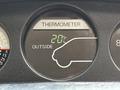A dashboard thermometer display showing an outside temperature reading of 20 degrees Celsius with an outline of a vehicle icon