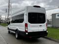 A white 2021 Ford Transit van parked with a tall rear and side windows showing a spacious interior design