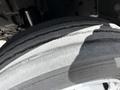 A close-up of a tire from a 2018 Hino 195 displaying tread patterns and wear with a shadow across the surface