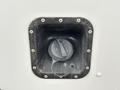 A close-up view of the fuel filler neck of a 2017 Ford Econoline with a black cap secured by a tether