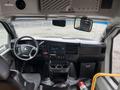 Interior view of a 2017 Chevrolet Express showing the driver's seat dashboard steering wheel and console with various controls and displays