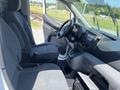 Interior of a 2019 Nissan NV200 with two front seats a center console and dashboard controls