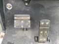 The image shows the foot pedals of a 2000 Ez-go Industrial 800 including the park brake pedal on the left and the throttle pedal on the right