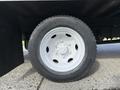 A close-up view of a white wheel from a 2007 GMC W5500 18 foot cube van showing the tire tread and wheel rim with six bolts