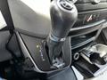 Gear shift of a 2017 Mercedes-Benz Sprinter with leather covering and various drive settings indicated on the panel