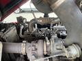Close-up view of the engine components of a 2014 Toro Groundmaster 5910 featuring various pipes and valves