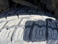 Close-up of a tire on a 2014 Ford F-150 showcasing its tread pattern
