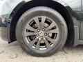 A close-up of a black alloy wheel from a 2014 Honda Odyssey featuring multi-spoke design and a tire labeled Nexen 225 65R17