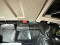 A digital brake controller mounted inside a vehicle with a red button and labeled as Reese