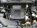 Engine bay of a 2021 Subaru WRX featuring a turbocharged flat-four engine with various components like hoses and caps clearly visible