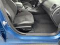 Interior view of a 2022 Dodge Charger showing black suede and leather seats with a center console and gear shifter