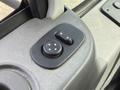 A close-up view of the control panel in a 2011 International 4300 featuring two black buttons with arrow symbols for adjusting seating positions