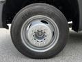 A close-up view of a silver wheel with a multi-bolt pattern on a 2016 Ford F-550 tire featuring a Continental brand name on the sidewall
