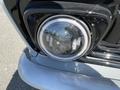 Close-up of the headlight of a 1962 Ford F-100 featuring a round design with a clear lens and chrome trim