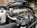 A close-up view of the engine of a 2006 Hino 268 featuring various mechanical components including pipes wires and a visible oil filter
